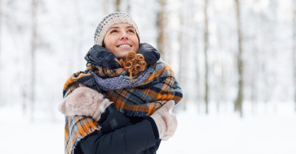 A woman smiling while outside during winter