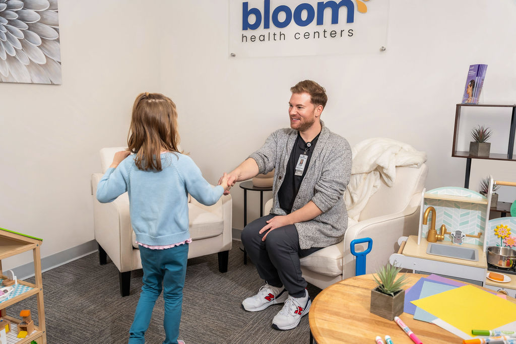 Health care worker shaking hands with child