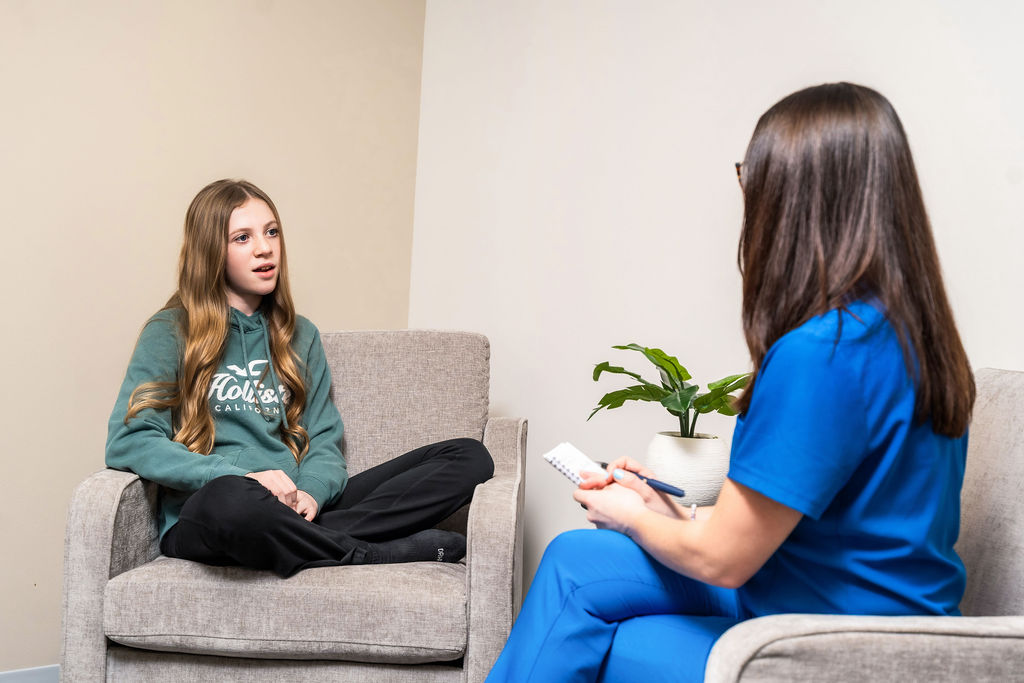 Health care worker consulting with young patient