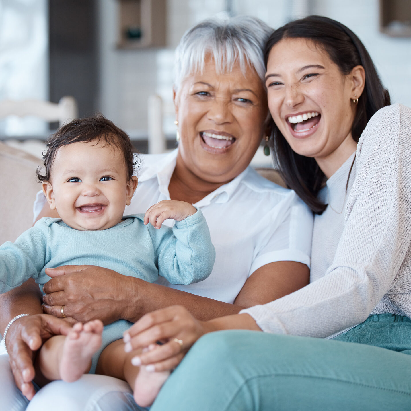Shot of a mature woman bonding with her granddaughter and daughter on the sofa at home Couldn't be happier
